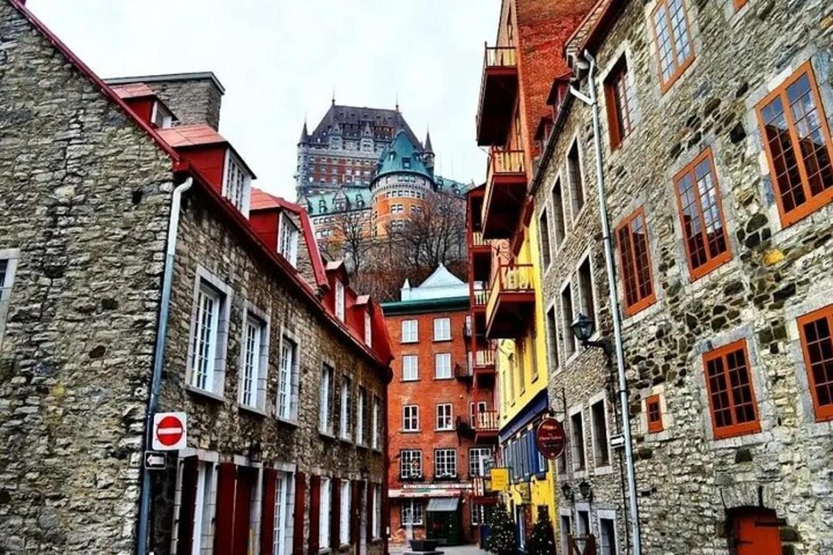 a city street with buildings and a castle in the background