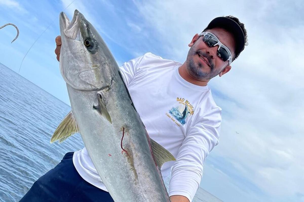 a man holding a fish in his hand