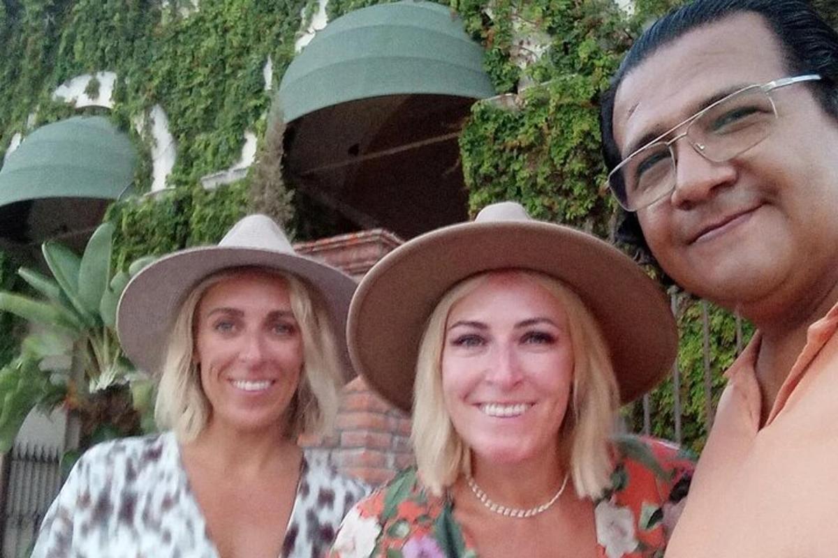two women and a man wearing cowboy hats