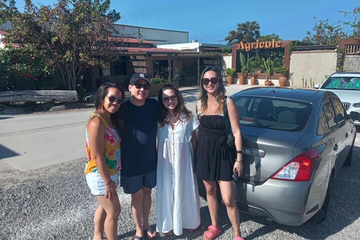 a group of people standing next to a car