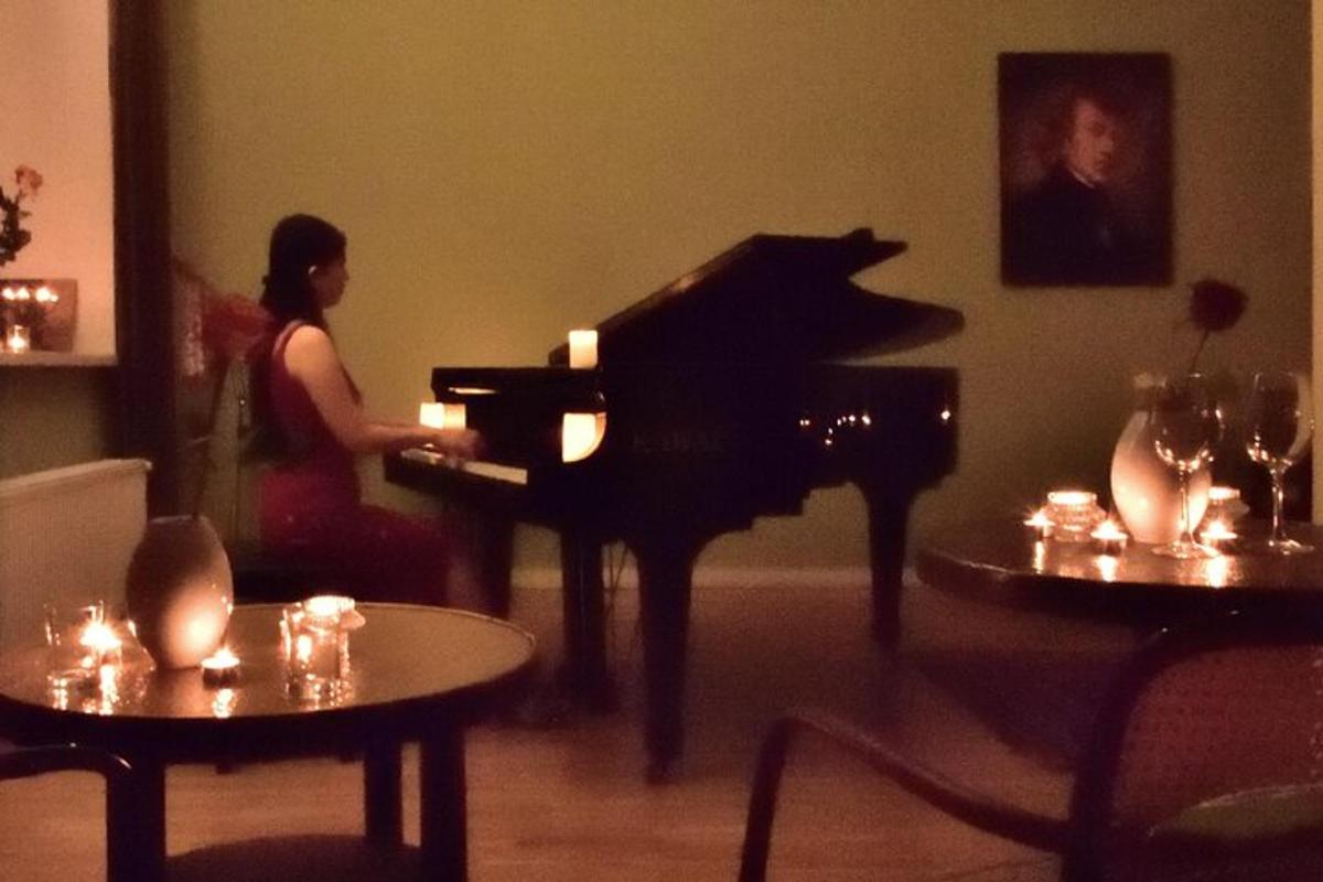a woman playing a piano in a living room