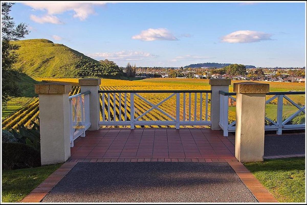a porch with a view of a field and a hill