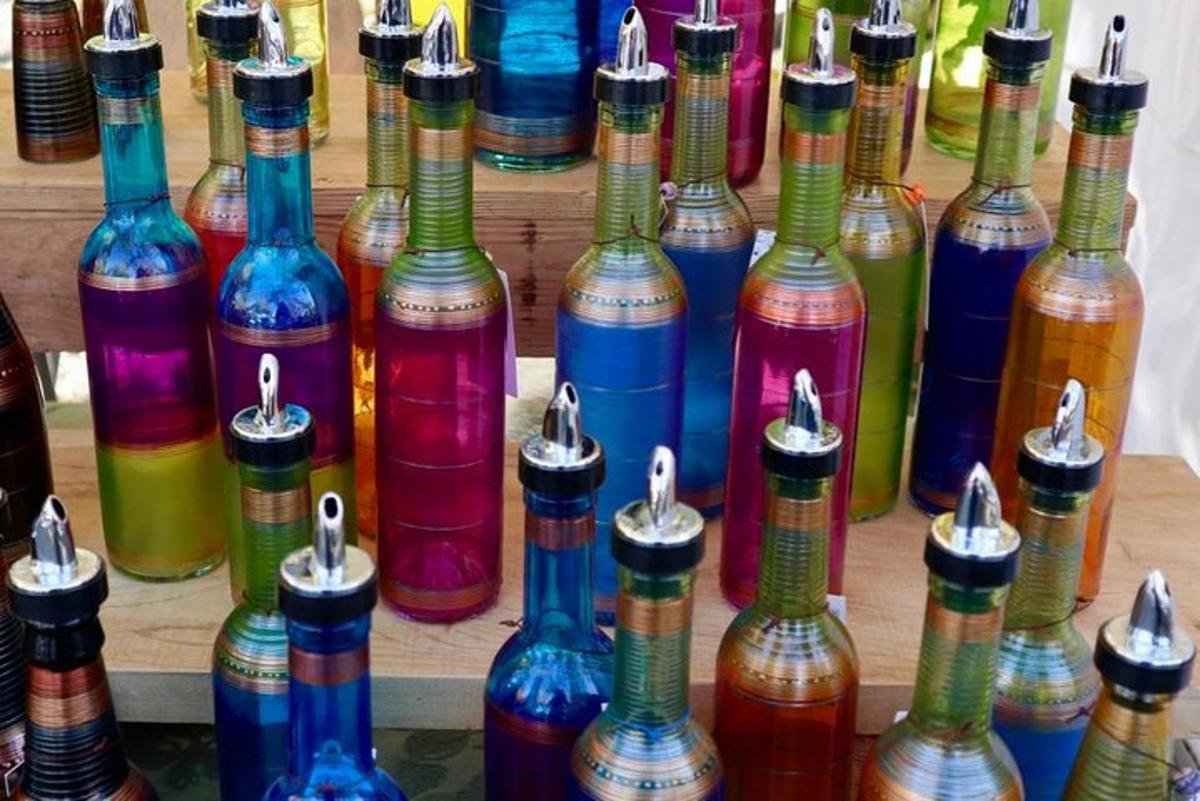 una mostra di molte bottiglie di vetro di diversi colori