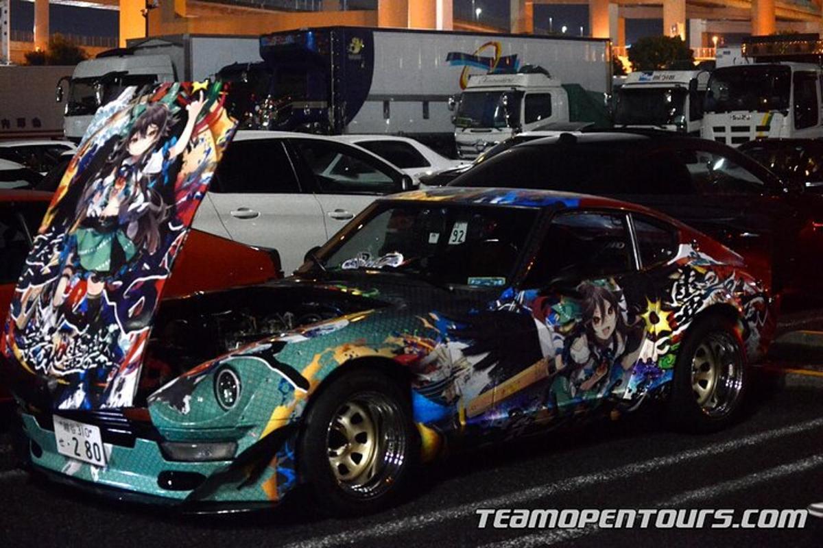 a car covered in graffiti parked in a parking lot