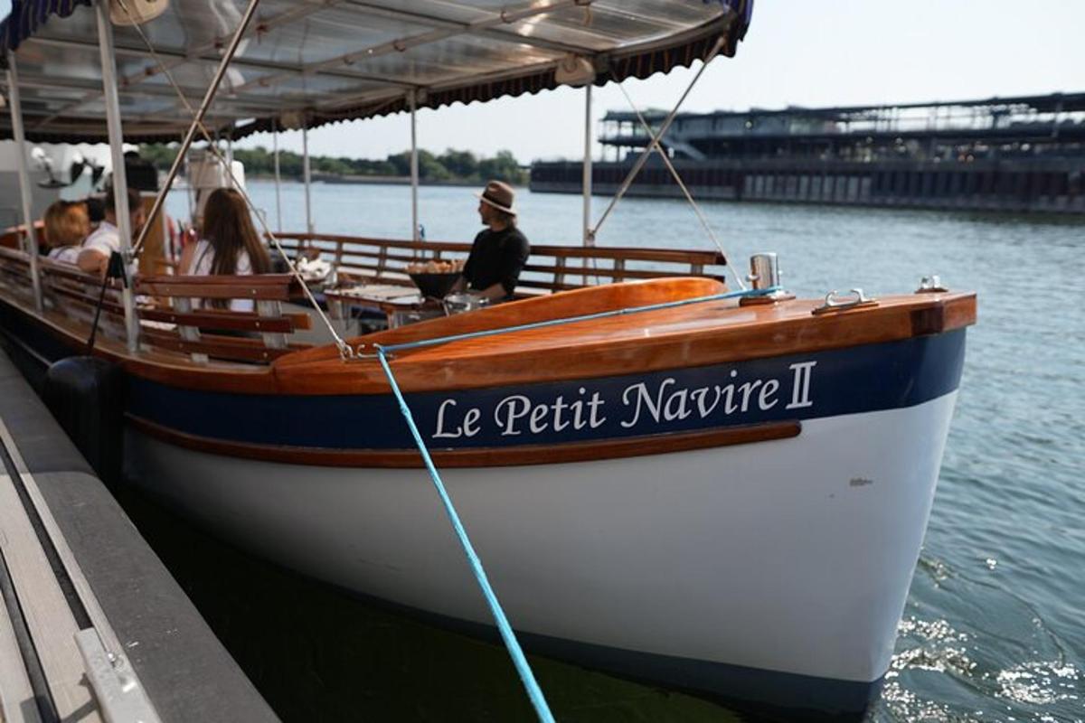 a boat tied to a dock with people on it