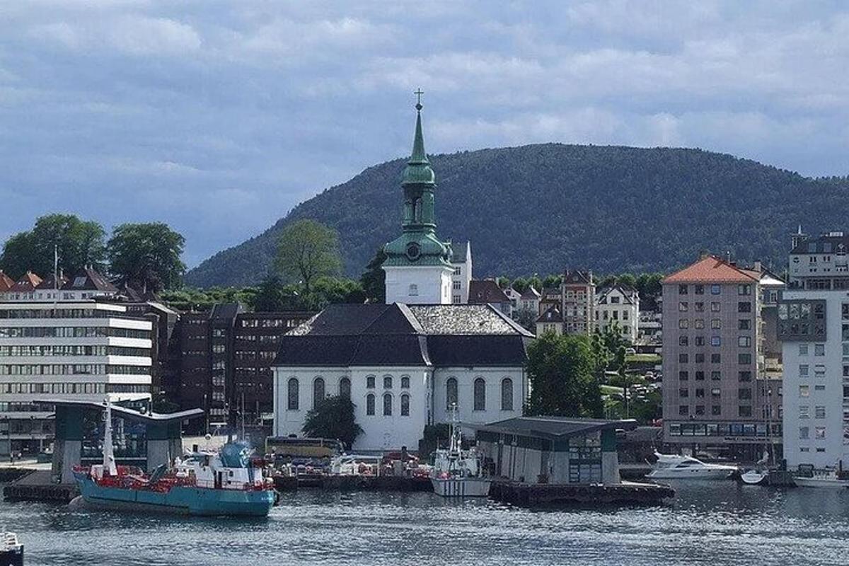 a large white building with a steeple on the water