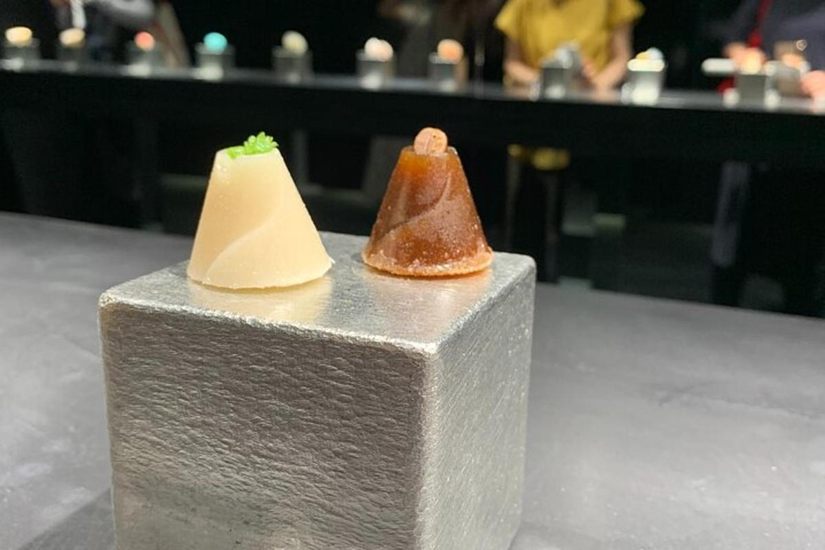 two pieces of food sitting on top of a block