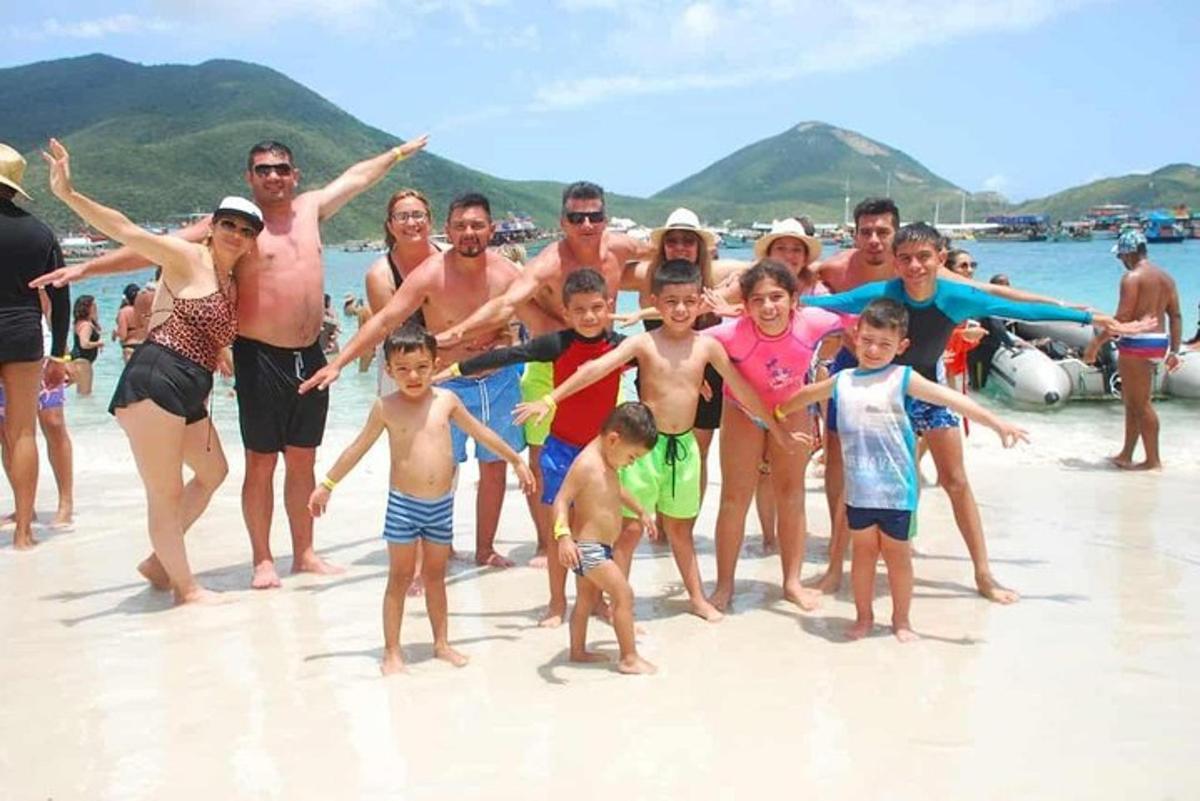 Un grupo de personas posando para una foto en la playa.