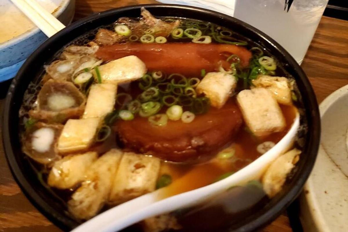 a bowl of soup with meat and vegetables in it