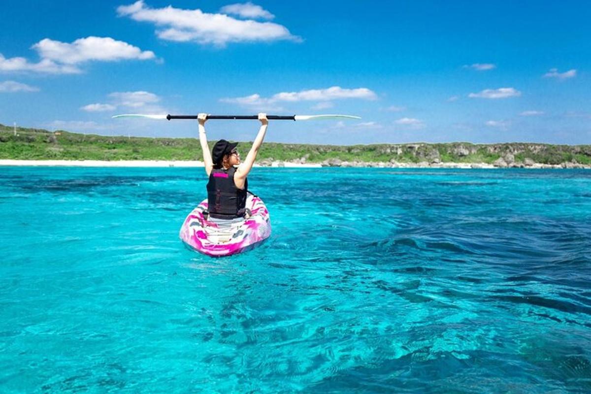 a person is holding up a paddle in the water