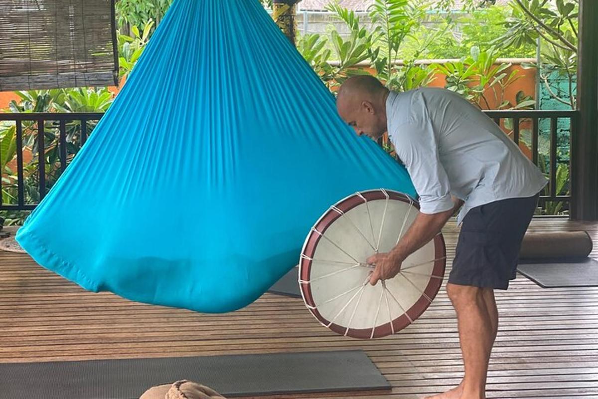 a man is holding a bike tire on a deck