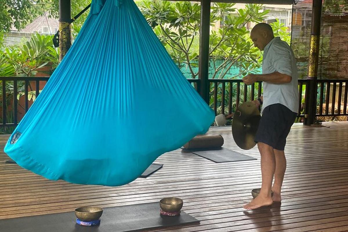 a man standing next to a blue net