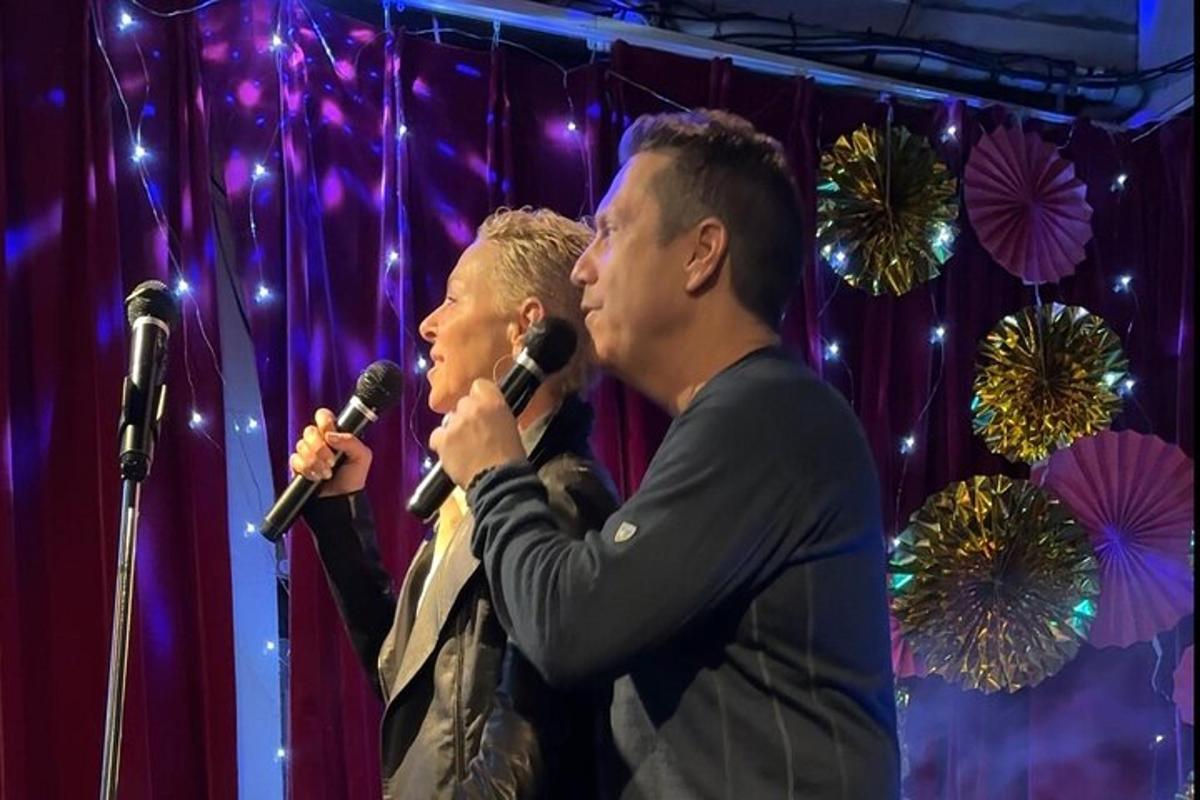 two men standing in front of microphones