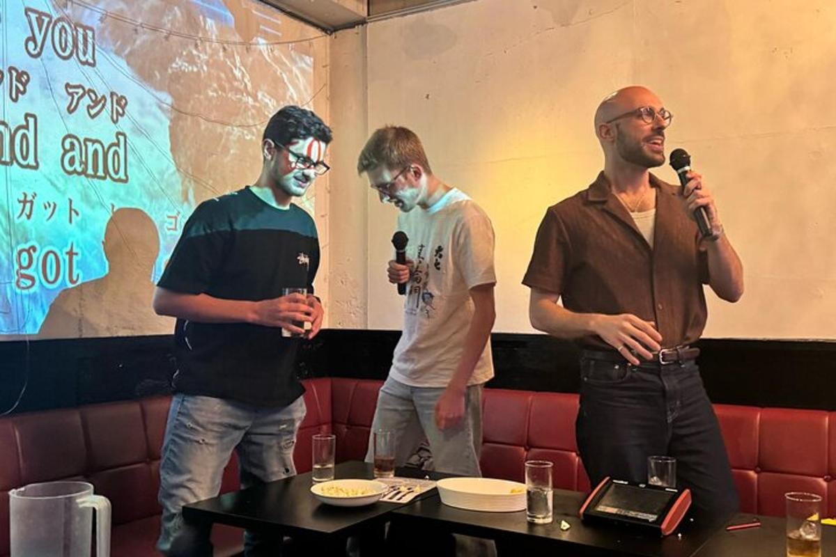 a group of three men standing in a room with microphones