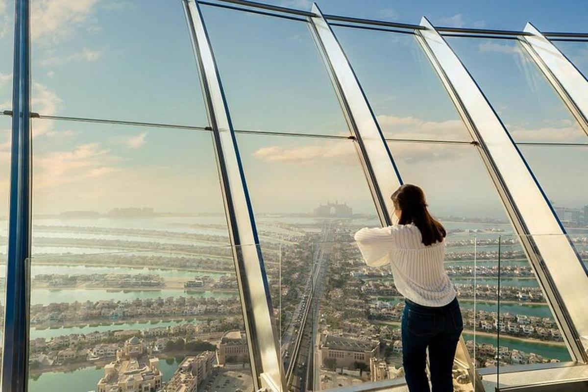 a woman looking at the city from the top of a skyscraper
