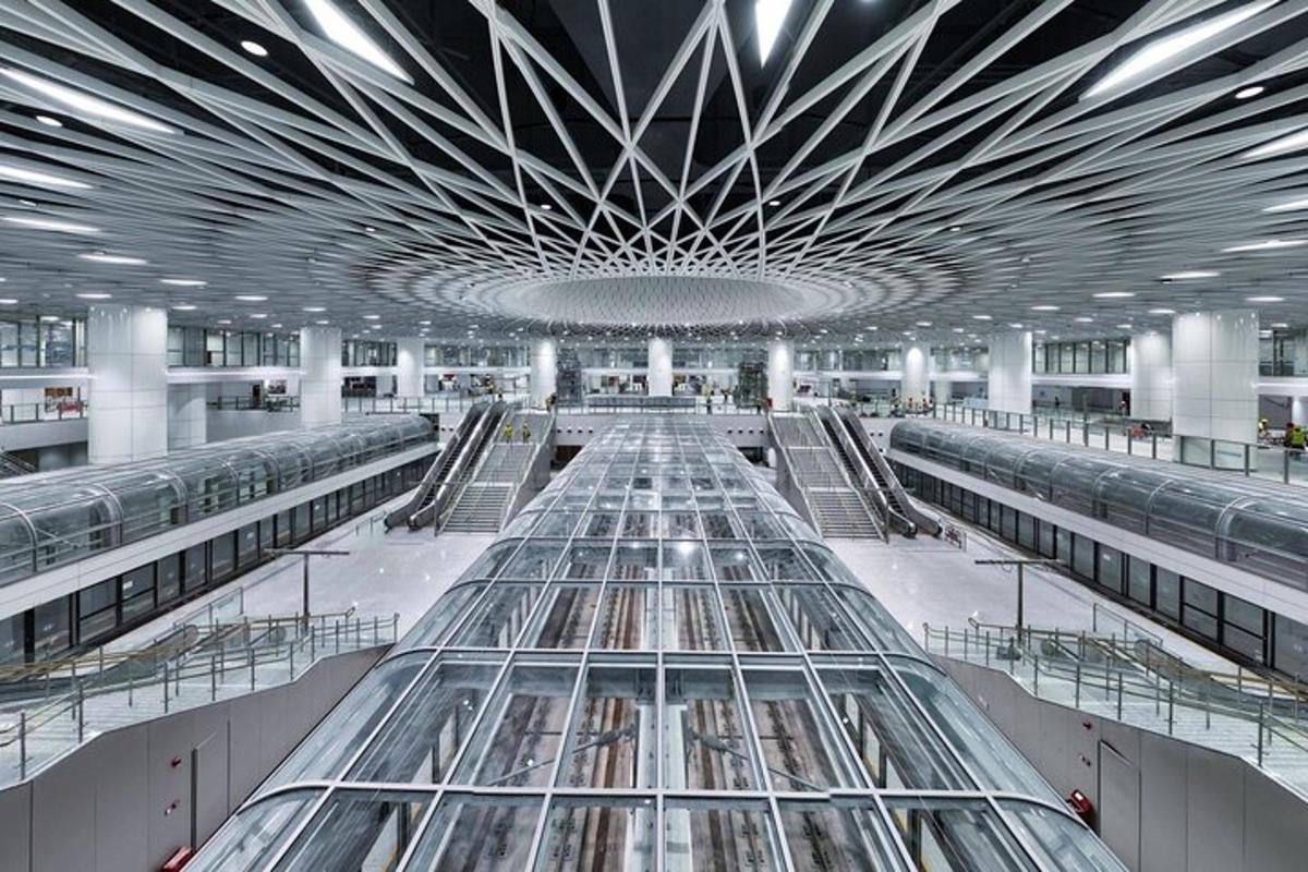 een grote luchthaven met een glazen plafond en roltrappen