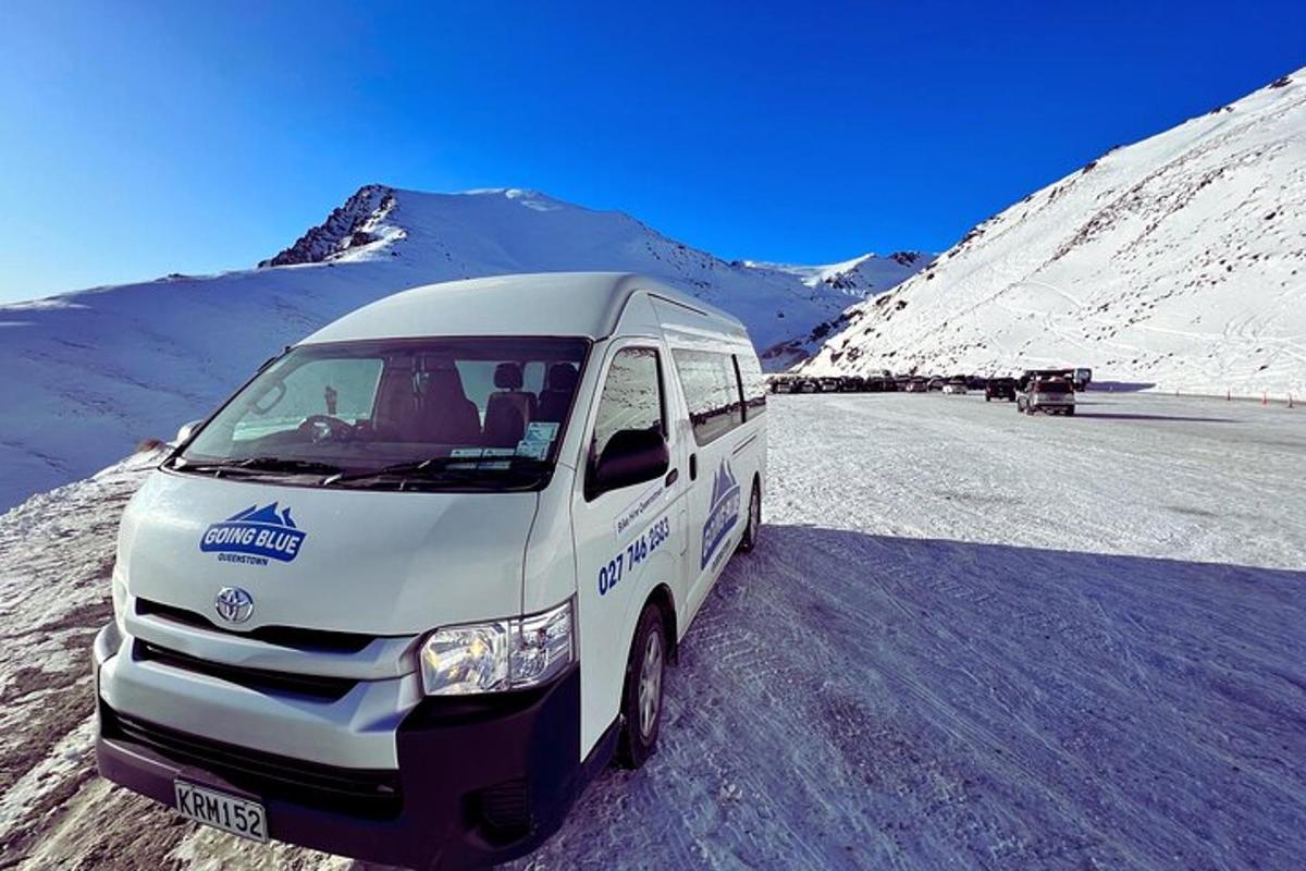 a white van parked on a snow covered road