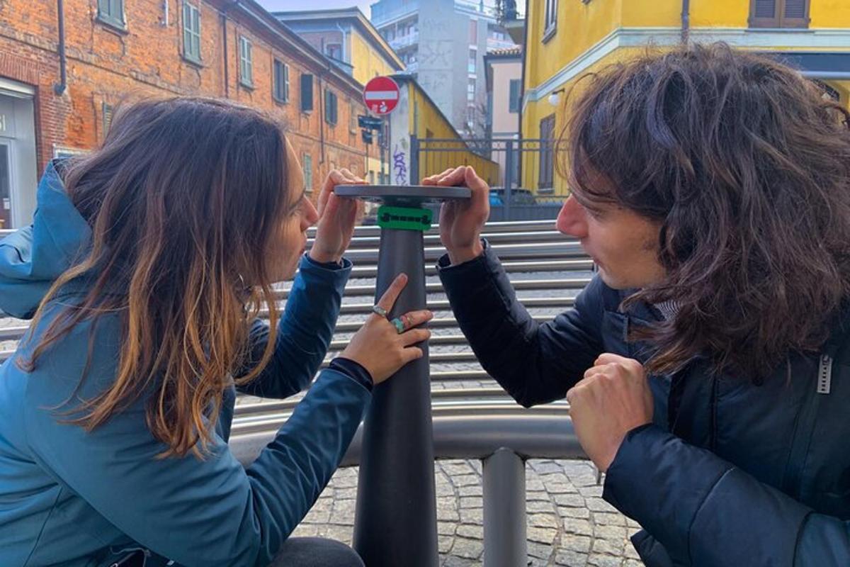 two women are looking at a sign on a pole