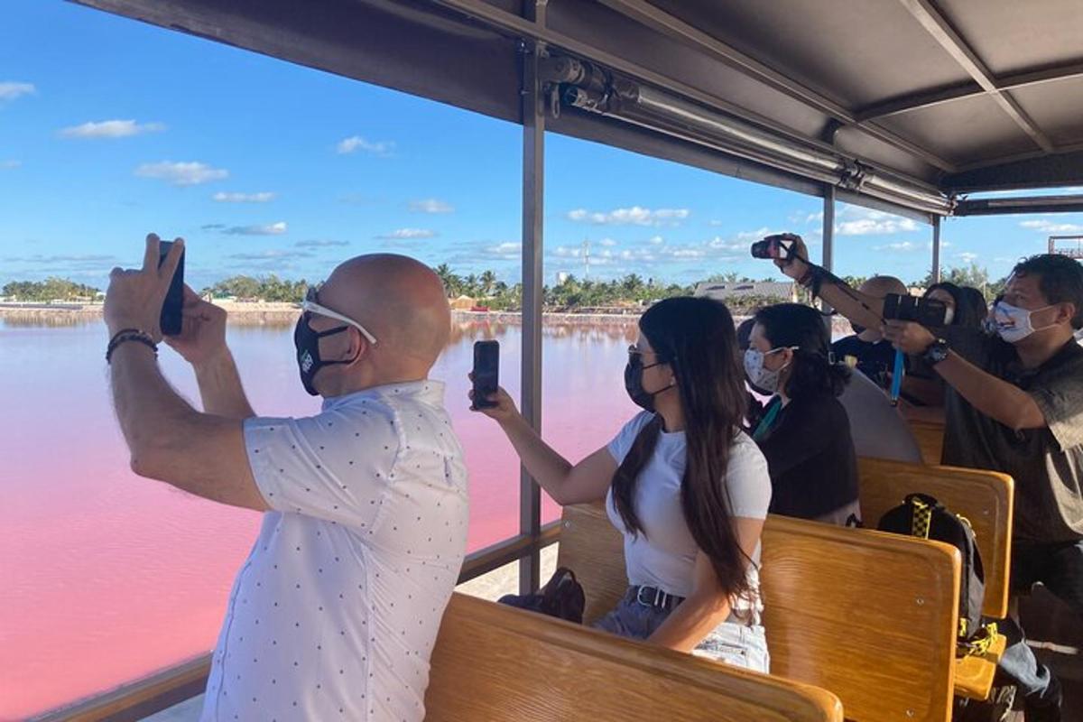a group of people taking pictures of the water on a boat