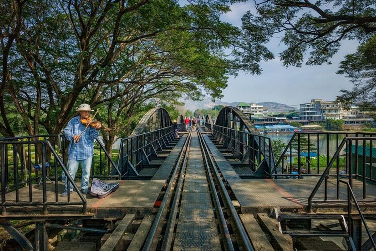 a man standing on a bridge over a river