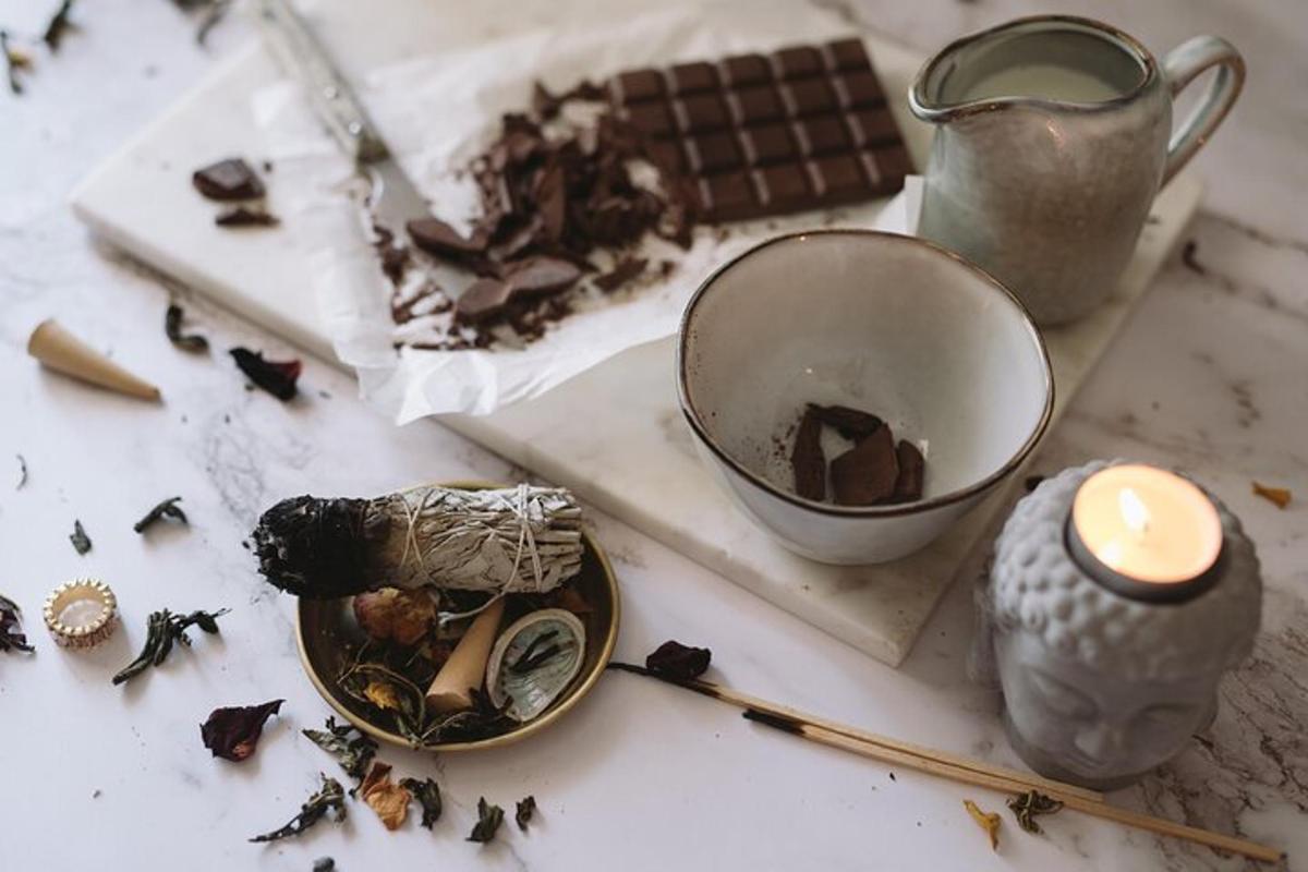 a table with a candle and a cup and debris