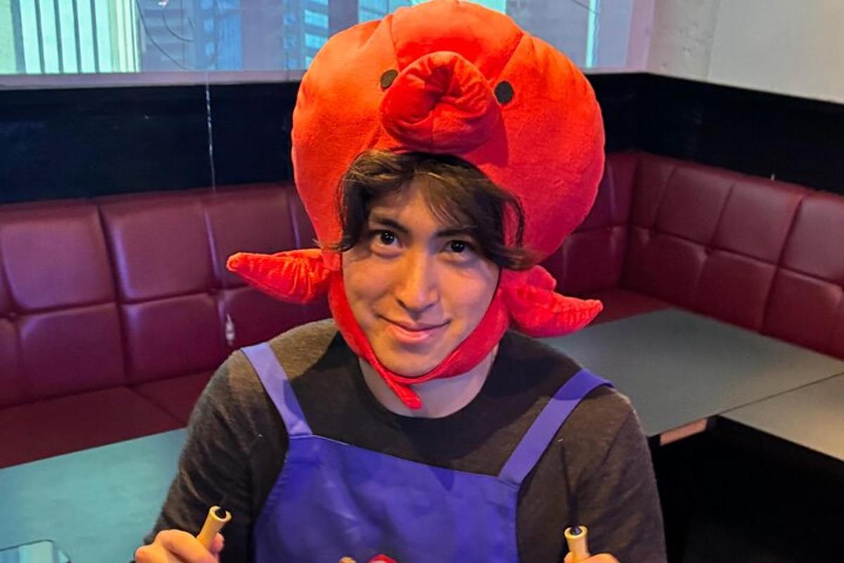 a man wearing a hat with a lobster on his head