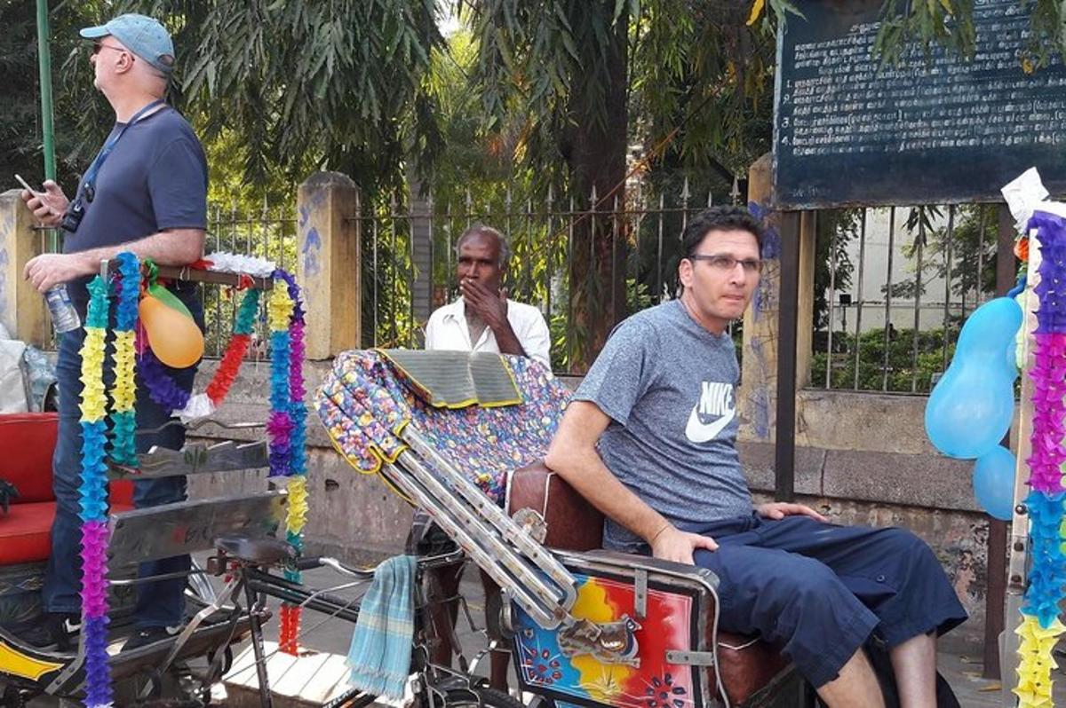 a man sitting on a cart with a man