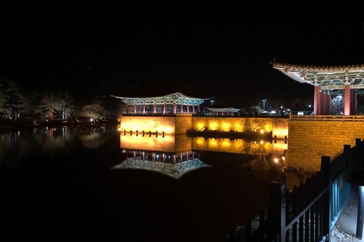 a building with lights in the water at night