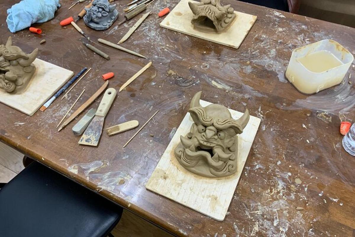 a table with some clay sculptures on it