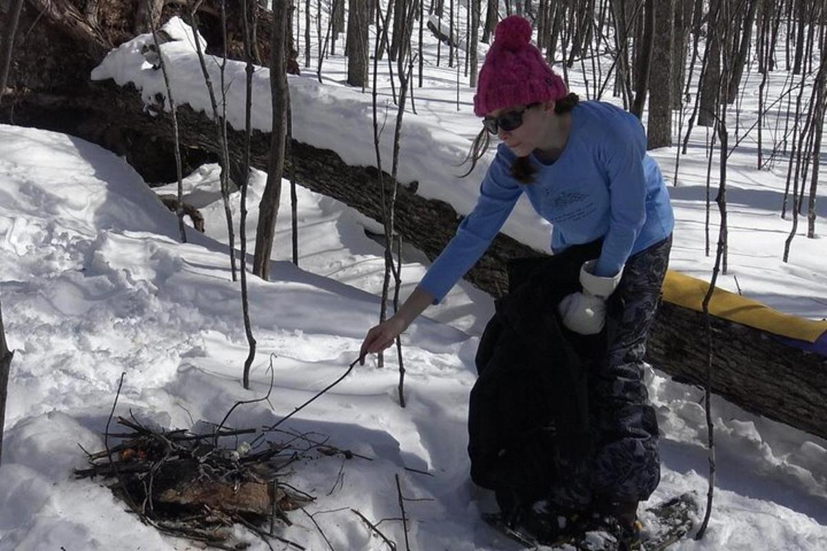 a young girl is playing in the snow