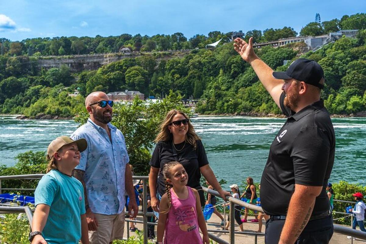 a group of people standing next to the river