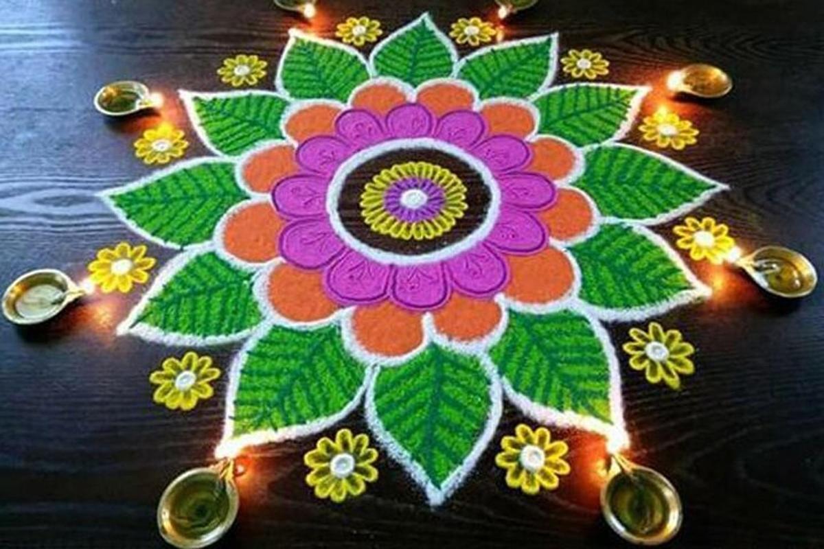 a rangoli of a flower on a table with lights