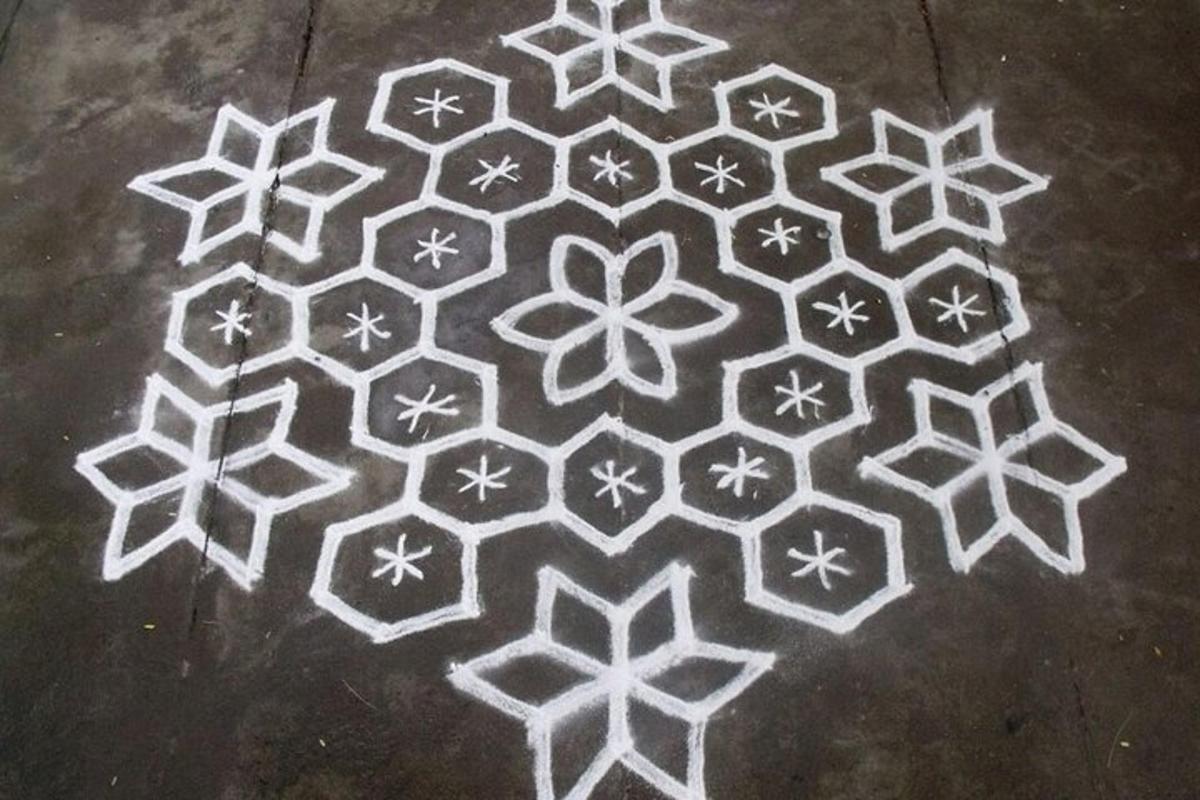 a rangoli design on a concrete floor