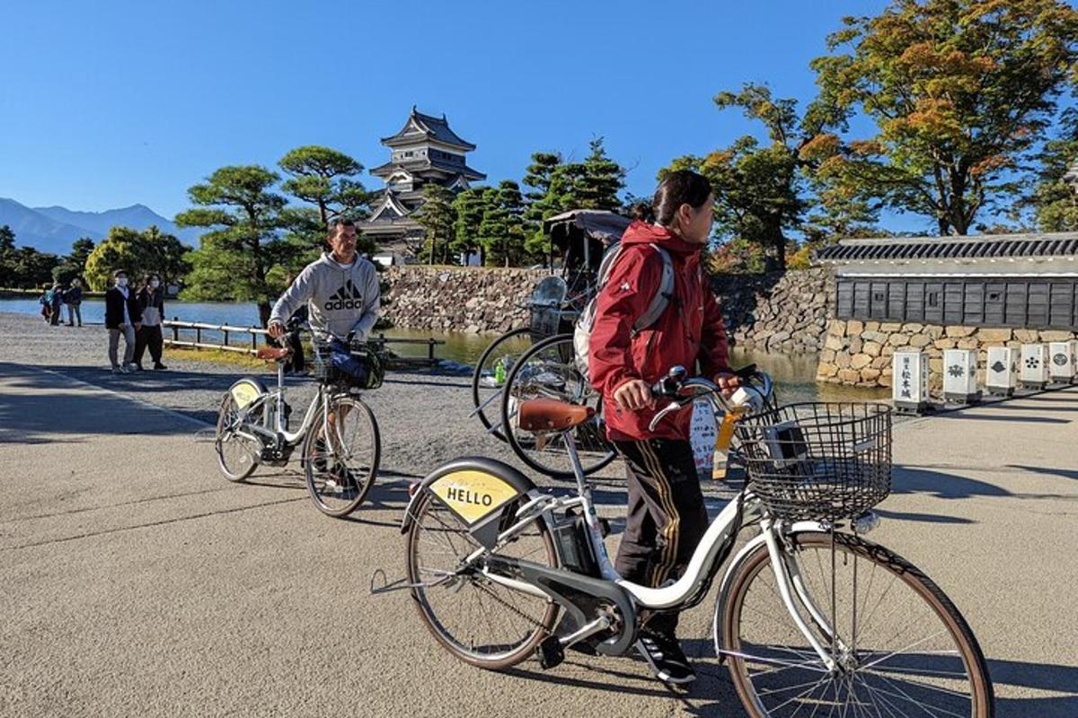 two men riding bikes down a street with
