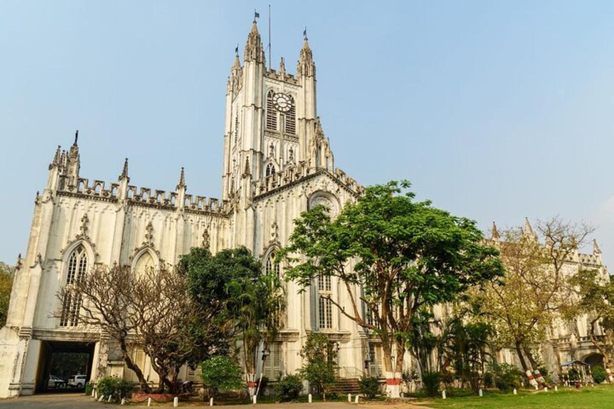 a large cathedral with a clock tower and trees