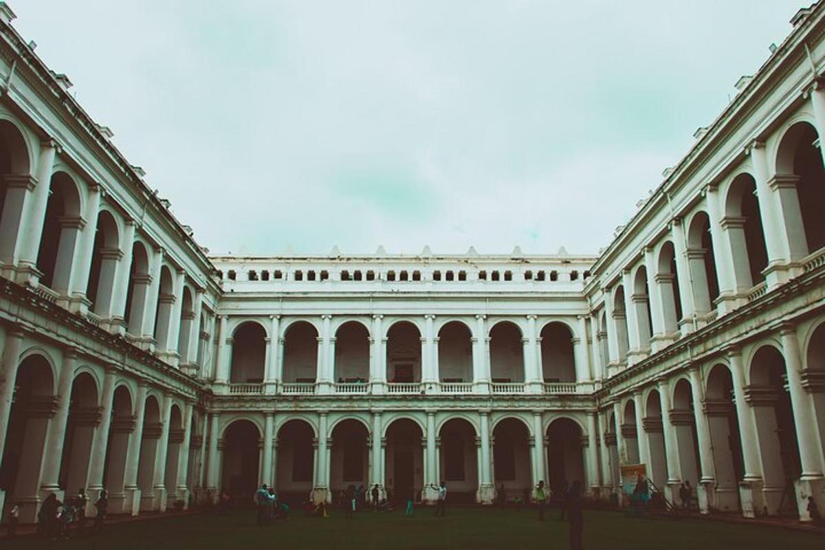 a large building with people standing in the courtyard