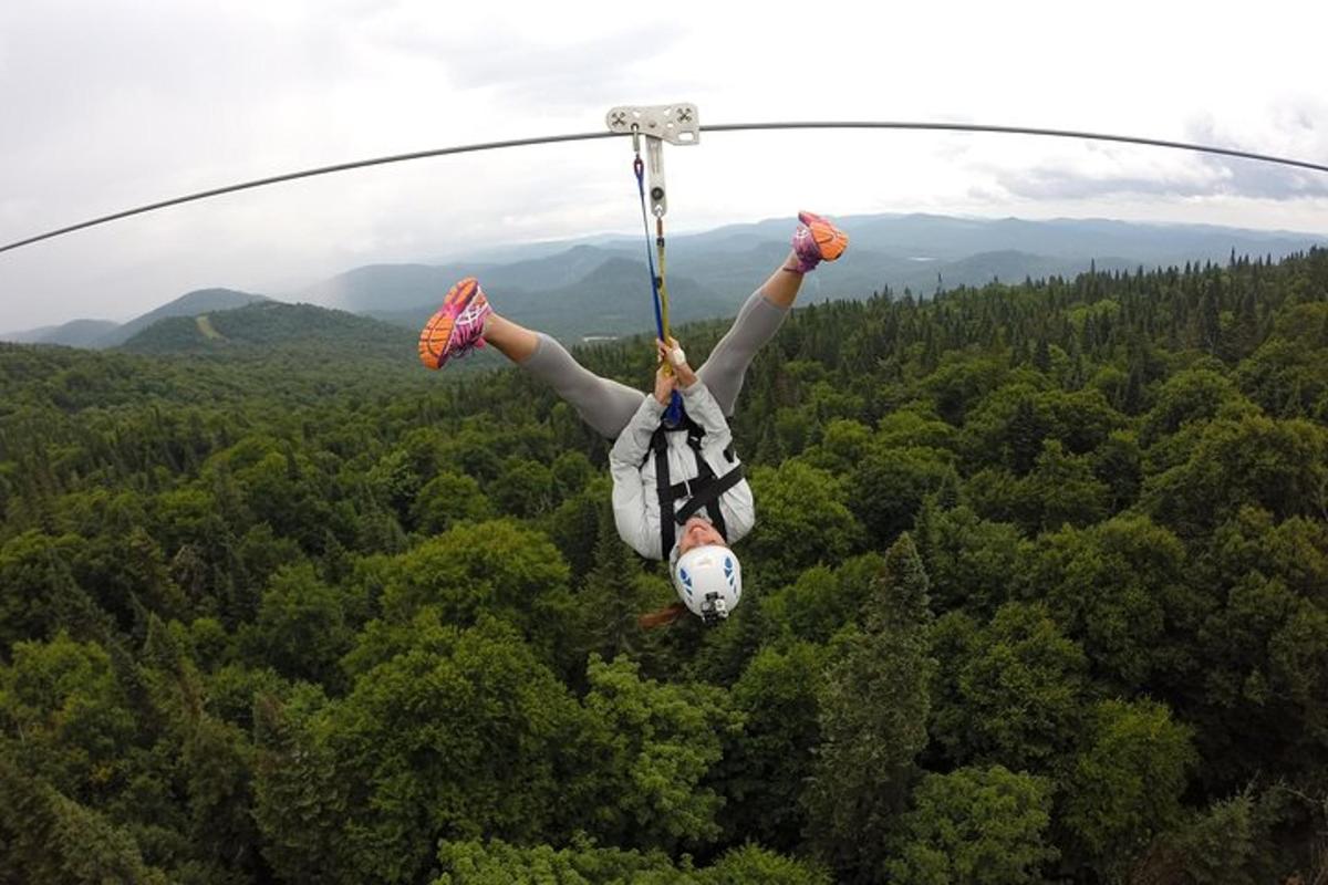 a person is hanging on a zip line
