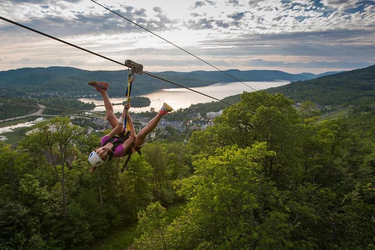 a woman is hanging on a zip line