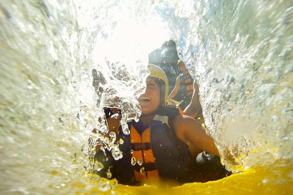 two people are in a wave in the water
