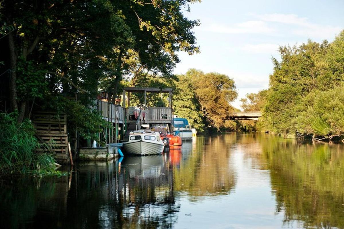 two boats are docked on a river with trees