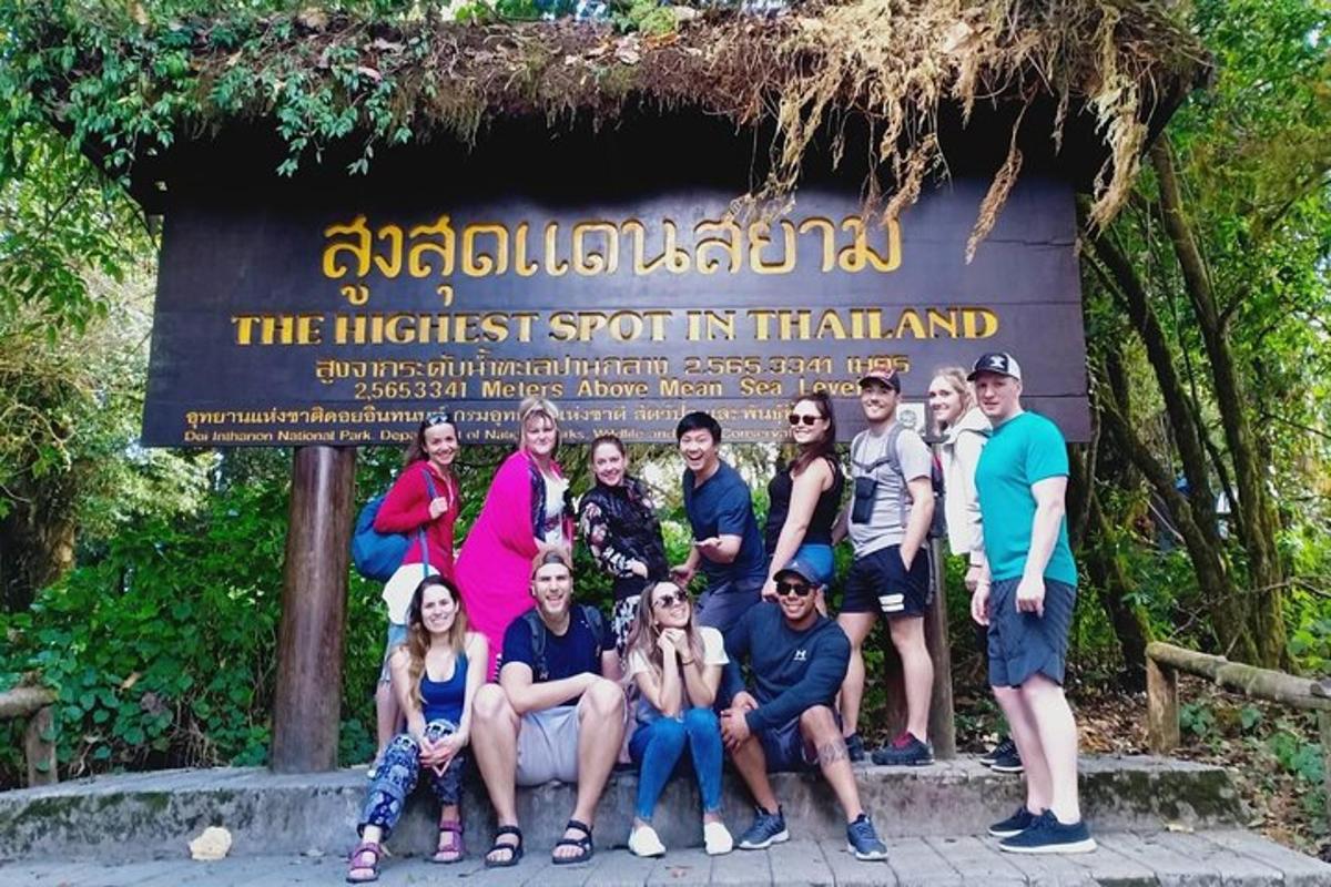 a group of people posing in front of a sign