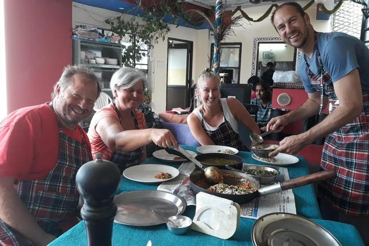 a group of people standing around a table with food