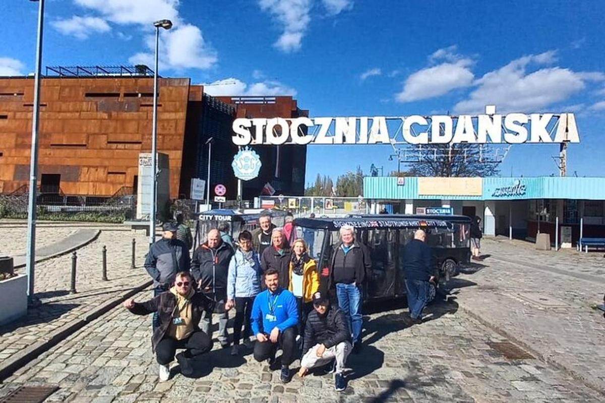eine Gruppe von Menschen posiert für ein Foto vor einem Gebäude