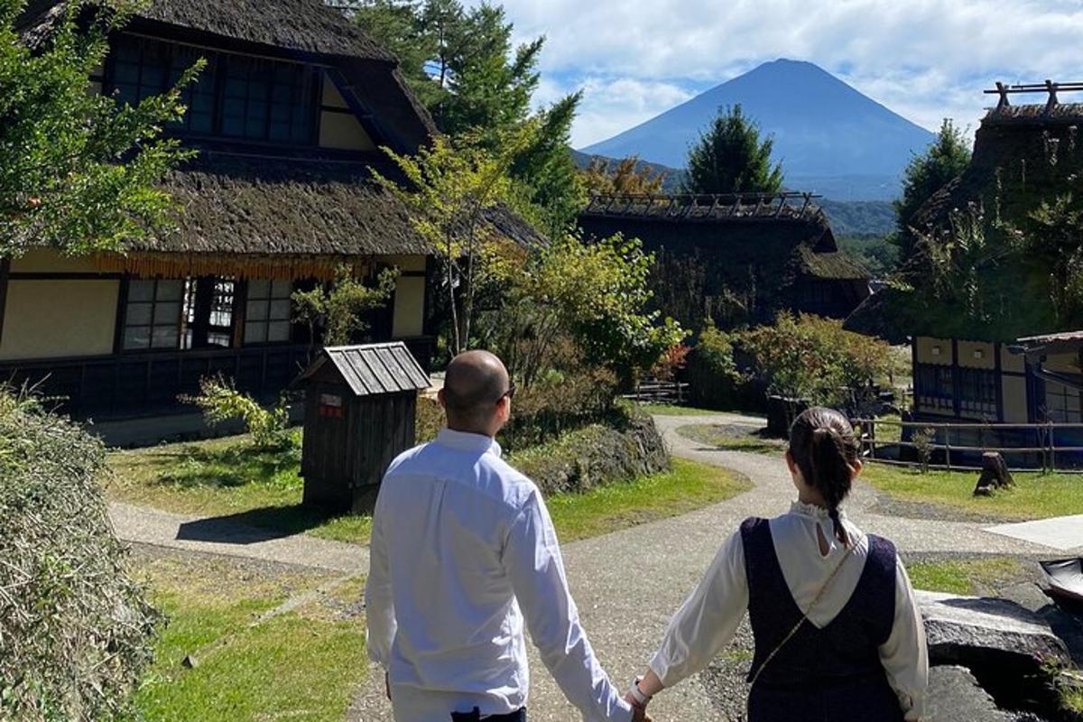 a man and woman walking down a road holding hands