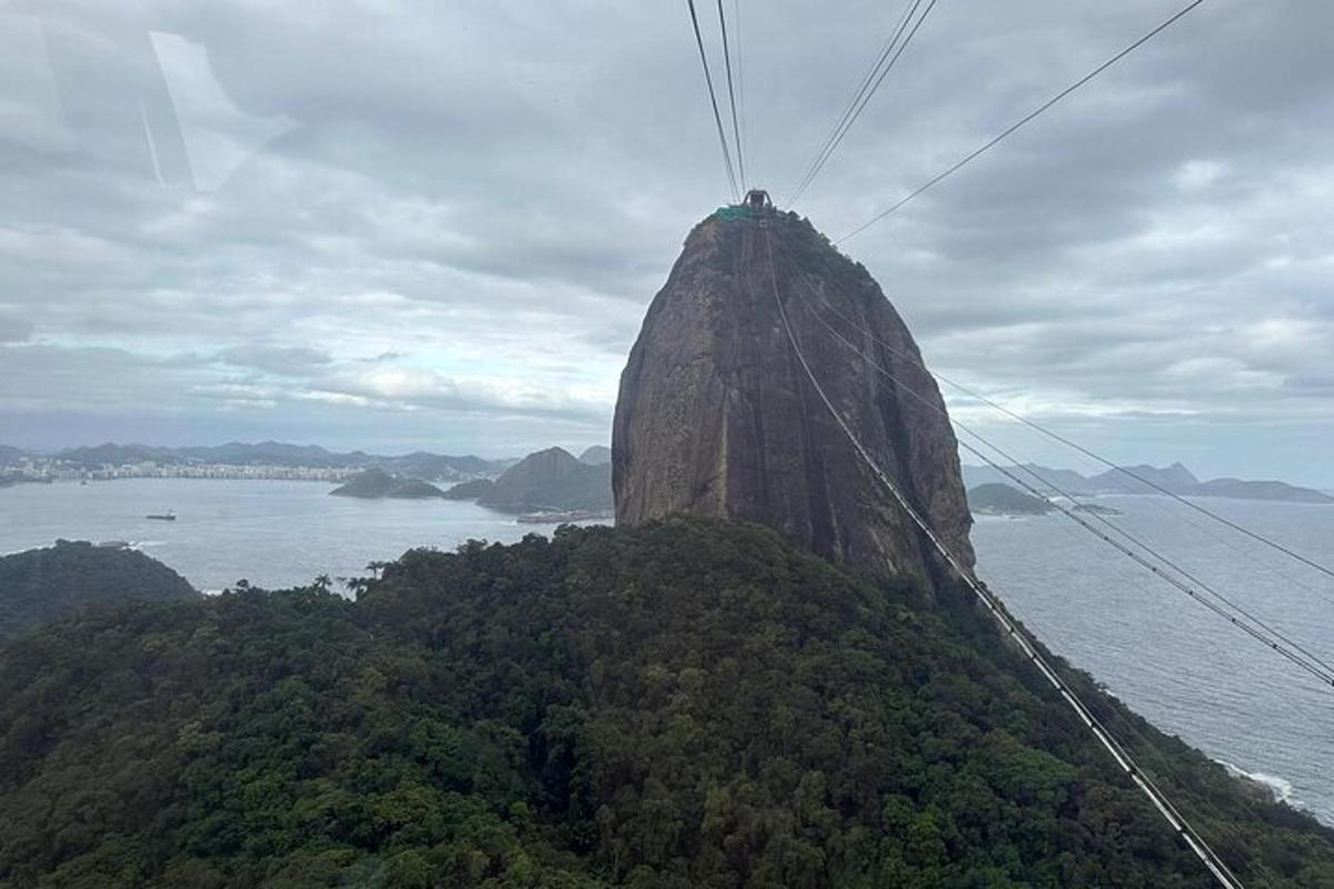 a mountain with a person sitting on top of it