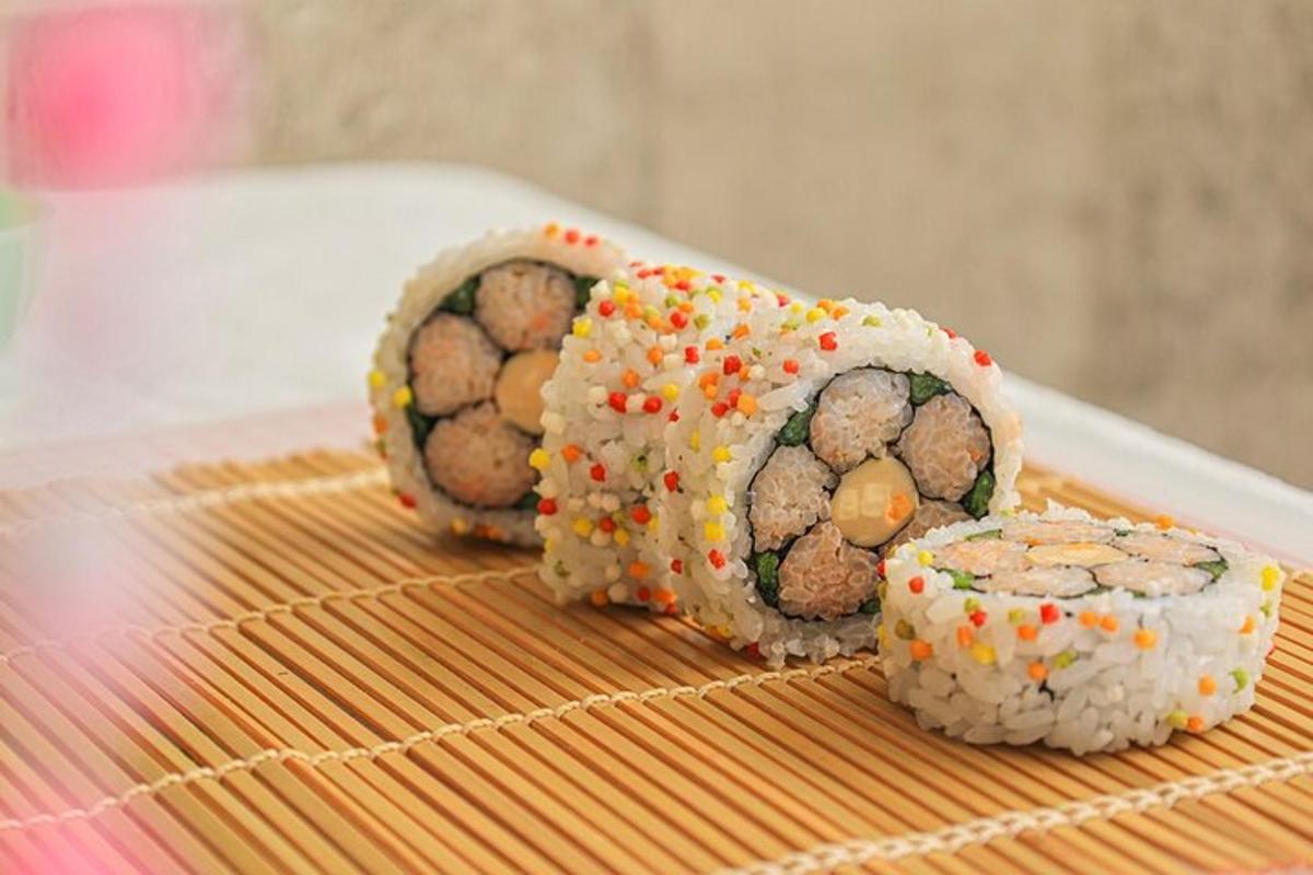 three sushi rolls sitting on top of a table