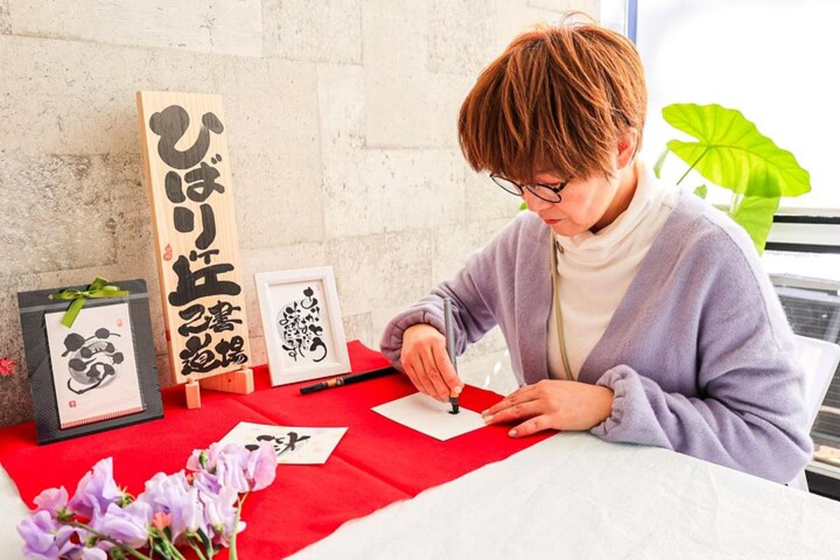 a woman sitting at a table cutting a piece of paper