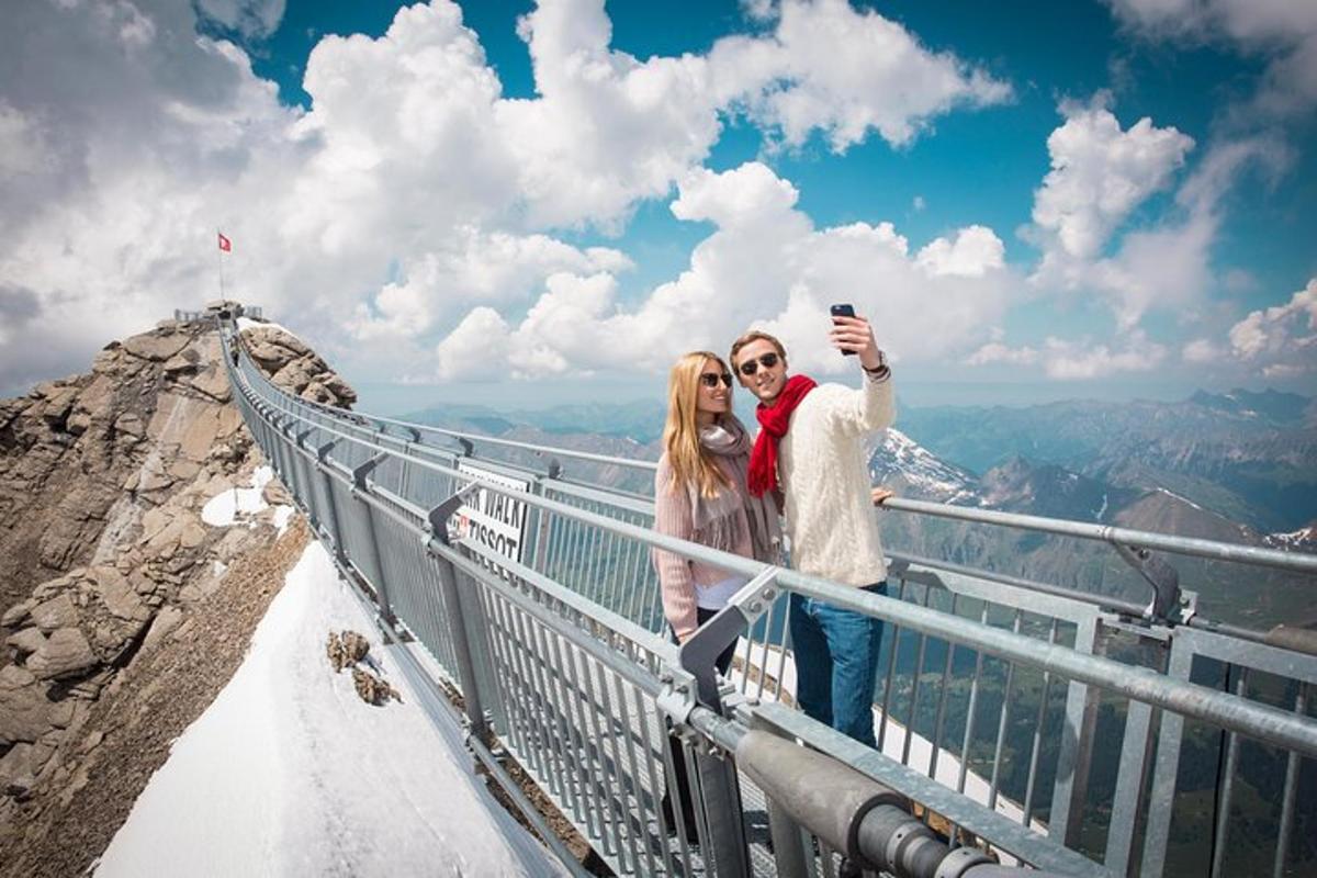 a man and woman taking a picture at the top of a mountain