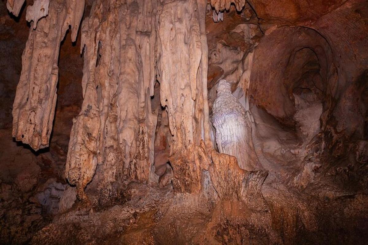 a cave with a statue of a woman in a cave