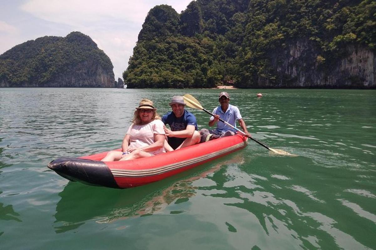a group of three people on a raft in the water
